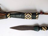 pair of african knife and sheaths on a white surface