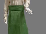 an image of a mannequin wearing a green skirt and white shirt