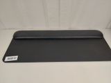 a close up of a black desk mat on a white surface