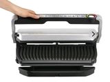 a close up of a person holding a sandwich maker in their hand