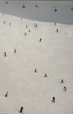 skiers and snowboarders are skiing down a snow covered mountain