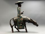 statue of a woman riding a horse with a hat on her head