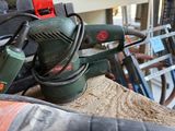 a sander sitting on top of a piece of wood