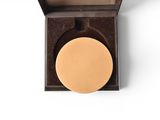 a close up of a gold medal in a box on a white background