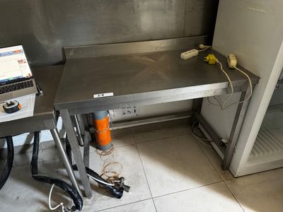 a laptop computer sitting on a table in a kitchen