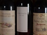 several bottles of wine are lined up on a shelf
