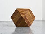 an image of a wooden cube sitting on top of a cement floor
