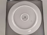 a white plate that is in a box on the table