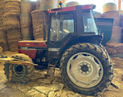 un tracteur garé dans une grange remplie de foin