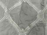 an image of a close up of a bed with a white comforter