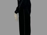 a mannequin dressed in a black coat and white pants