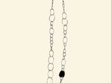 silver chain with a black square pendant and a black bead