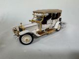 a toy car that is sitting on a white surface
