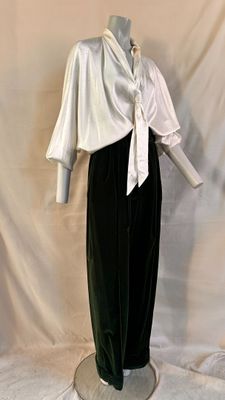 a mannequin dressed in a white shirt and black pants