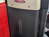 a close up of a machine in a room with a red wall