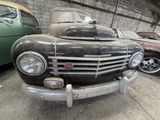 many old cars that are parked in a garage
