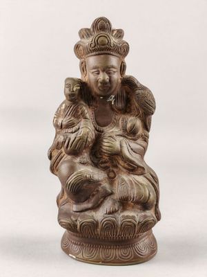 an image of a statue of a man holding a baby