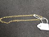 a close up of a gold chain with a tag on it