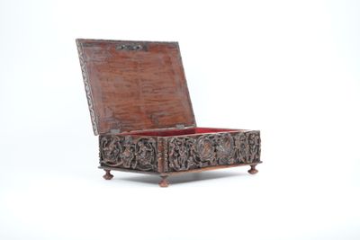 a small wooden box with carvings on it