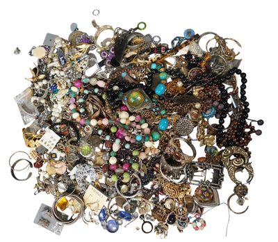 a pile of assorted jewelry on a white surface