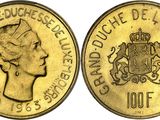 a close up of a coin with a woman ' s face on it