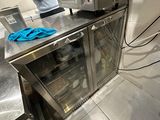 un homme debout dans une cuisine, devant un micro-ondes