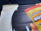 a bag of mustard sitting on top of a piece of paper