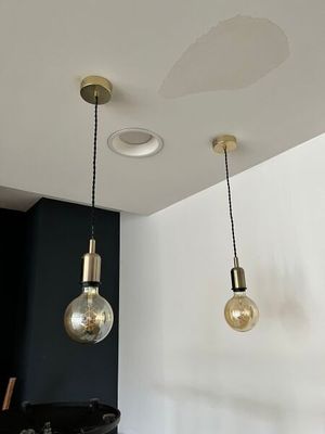 three lights that are hanging from the ceiling in the room