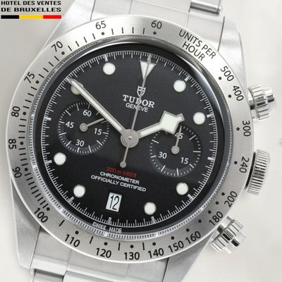 a close up of a watch on a white surface