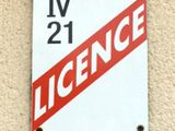 a red and white sign on the side of a building
