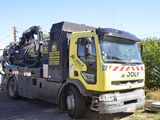 un camion jaune et noir garé sur le bord de la route