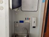 a sink and a tv in a small room