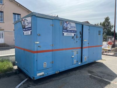 a blue portable toilet sitting in the middle of a parking lot