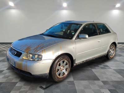 an image of a dirty silver car in a garage