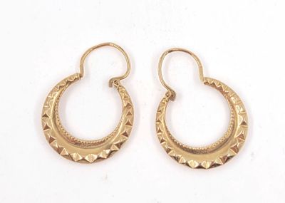two pairs of gold hoop earrings on a white background