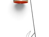 an orange floor lamp with a spider on the floor next to it