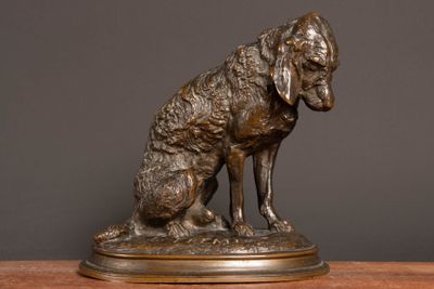 bronze statue of a dog on a wooden table