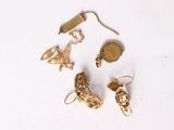 a lot of gold jewelry on a white surface