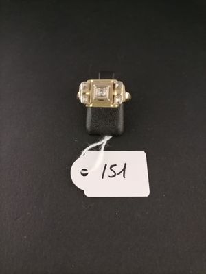 a close up of a ring on a black surface with a price tag