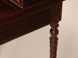 an antique writing desk with a drawer on top of it