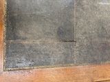 a picture of a black slate tile on a wooden door