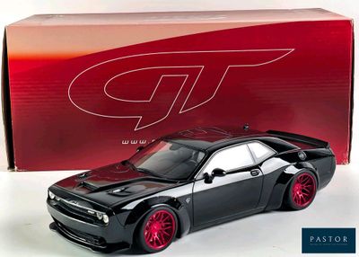 black and red model of a car in front of a red box