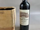 a bottle of wine sitting next to a wooden box