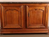 a wooden cabinet with a marble top on the floor
