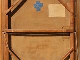 an old wooden box with a blue cross on it sitting on a wall