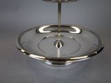 a silver plate with a candle holder on it