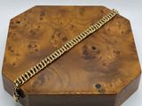 a close up of a wooden box with a chain on it