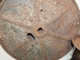 an old rusty wheel sitting on top of a white toilet