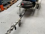 an image of a machine in a warehouse with pallets in the background
