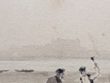 two people on the beach playing with a frisbee